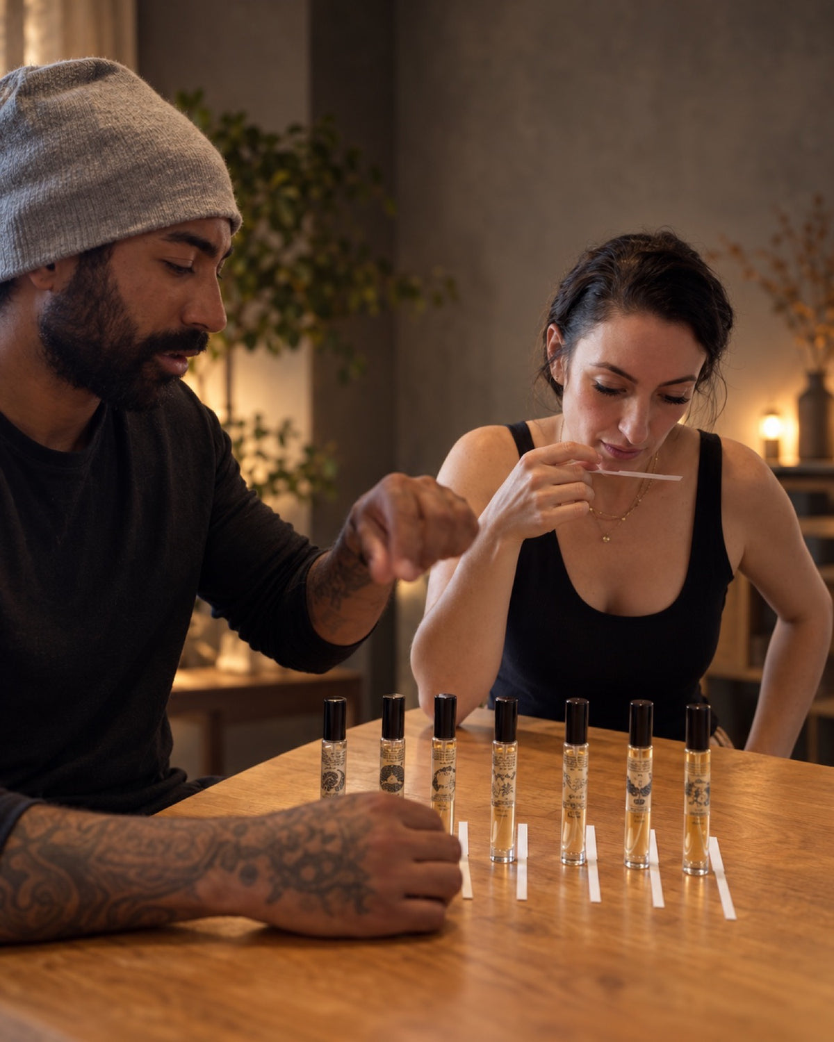 Andrew and Julia testing Opal Obscura fragrances on blotter strips at their studio table